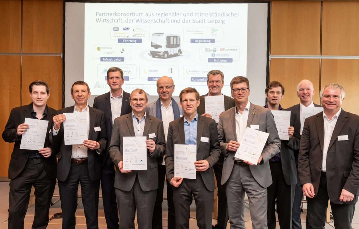 men standing on a stage and showing certificates